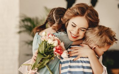 mom smiling and hugging her kids- subscription boxes for mom