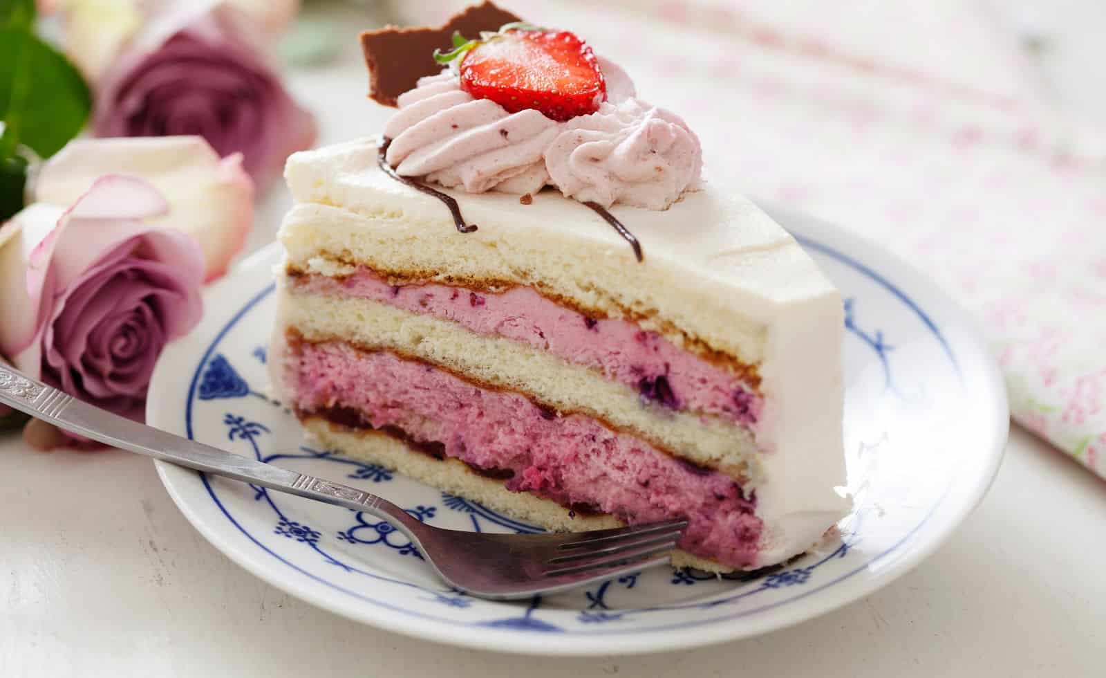 slice of layered cake with berry mousse and with chocolate icing